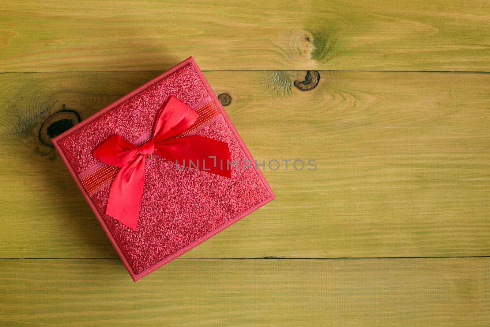 Gift in beautiful red box on wooden table by Bazdar