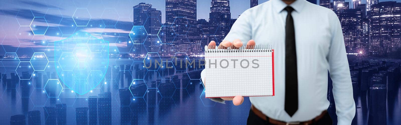 Picture Of Businessman Holding Empty Page Graphing Notebook Around Futuristic Technology. Employee Presenting Blank Workbook Surrounded By Modern Automation. by nialowwa
