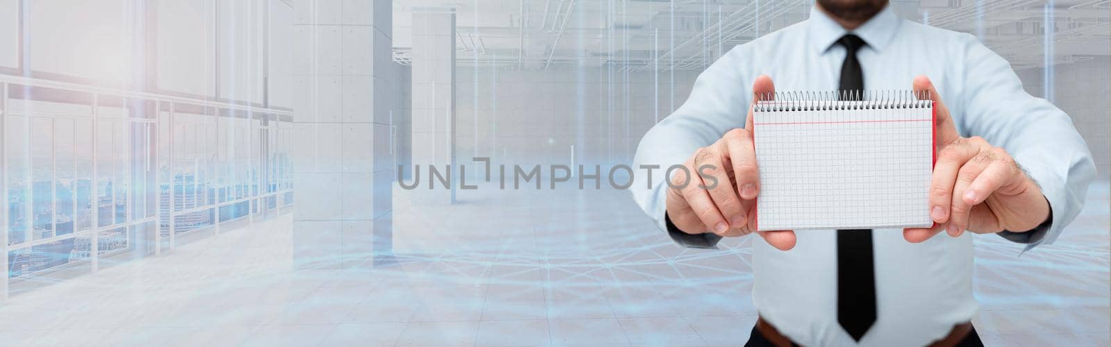 Businessman Holding Empty Page Graphing Notebook With His Both Hands Around Futuristic Technology. Employee Presenting Blank Workbook Surrounded By Modern Automation. by nialowwa