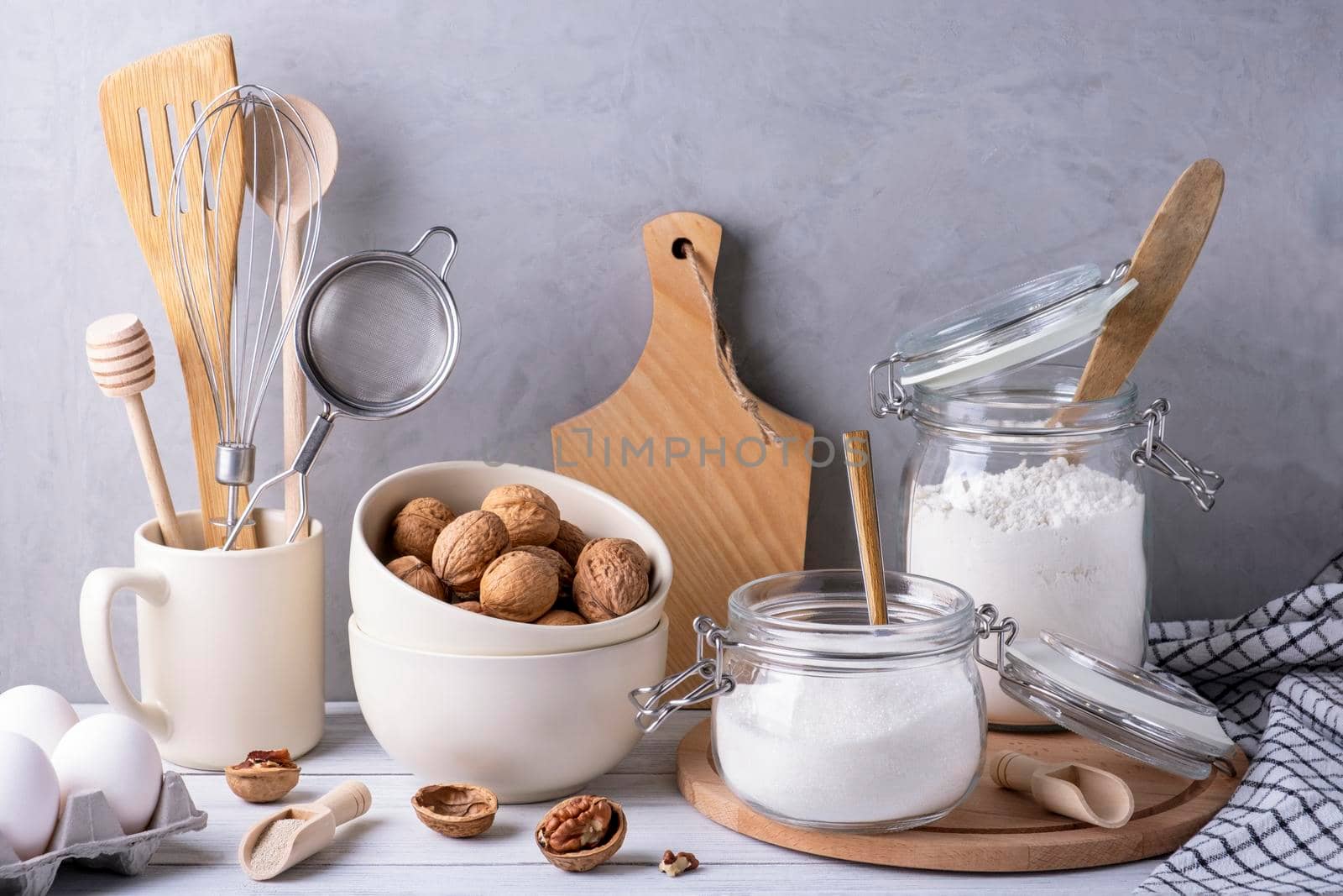 Close-up of kitchen utensils and containers made of wood, metal and glass. Ingredients for baking pie. Eco-friendly materials, no plastic concept. Selective focus.