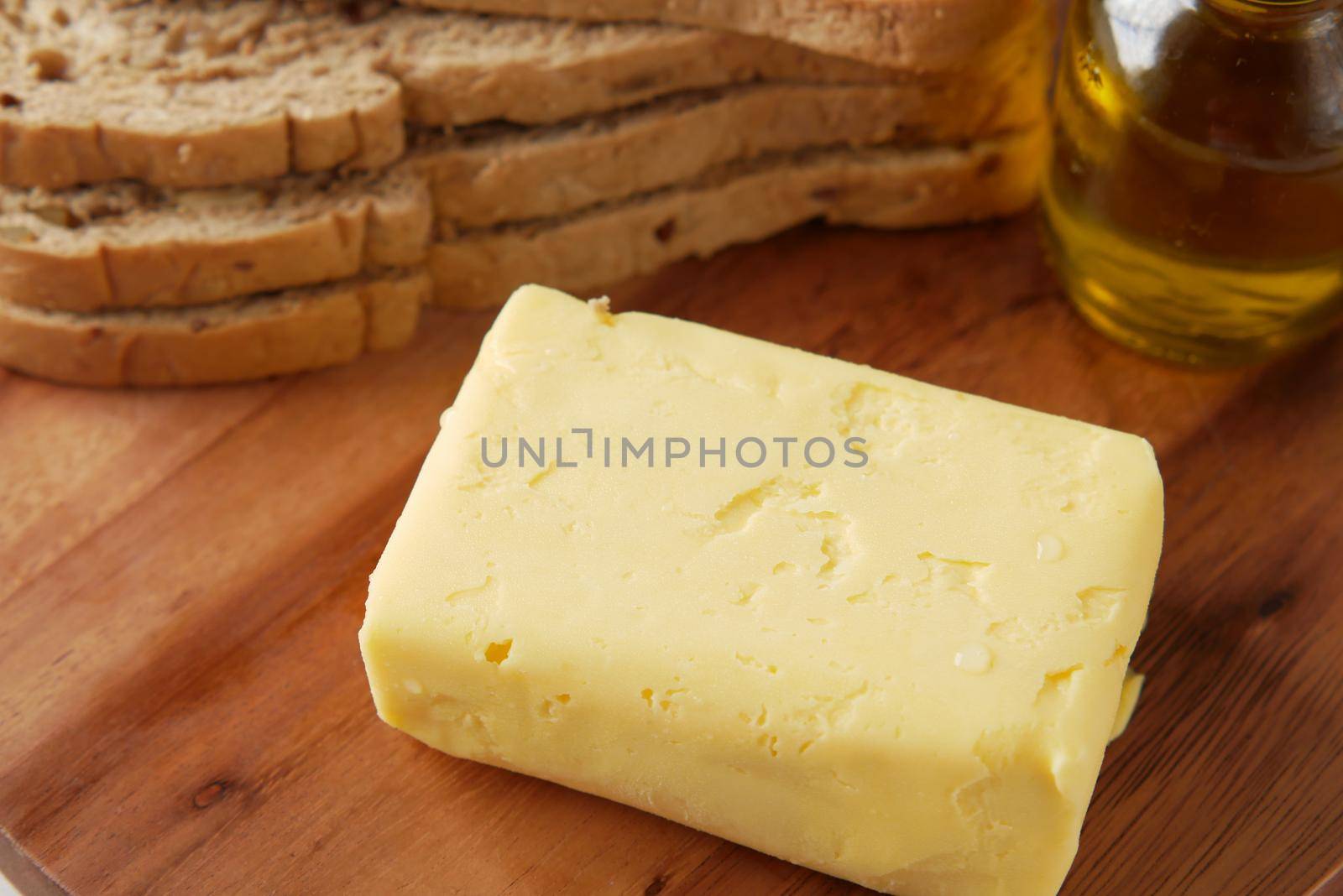 slice of a butter on a paper on table .