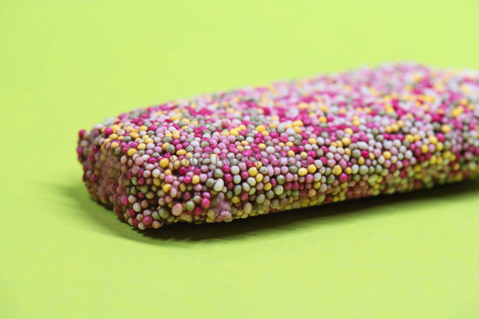 Ice cream on stick with colorful sprinkles by anytka