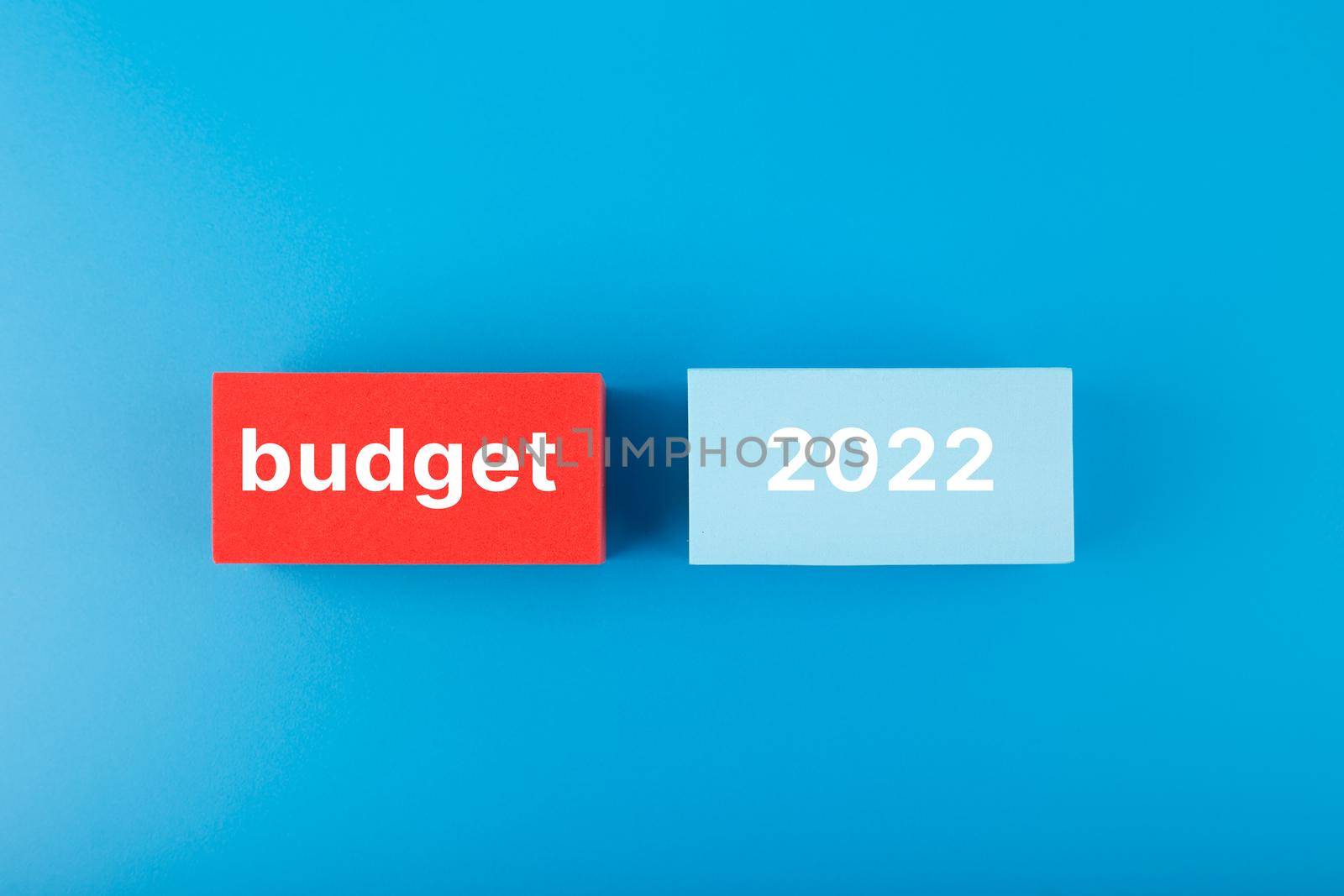 Business plan or budget concept 2022. Text budget 2022 written on red and blue rectangles on dark blue background by Senorina_Irina