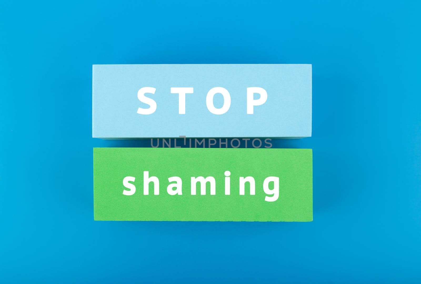 Stop shaming minimal concept. Minimal flat lay with text on blue background by Senorina_Irina