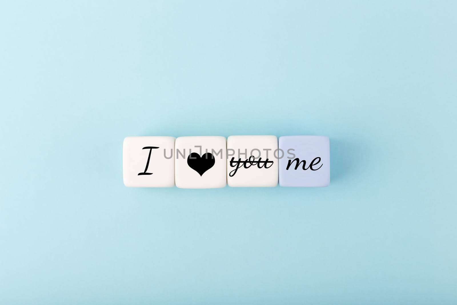 I love me modern minimal concept in pastel blue colors. Simple elegant flat lay with toy cubes with written text I love you, me by Senorina_Irina