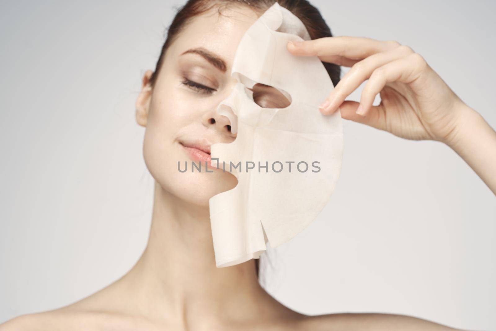 woman with bare shoulders and face mask skin care cosmetics by Vichizh