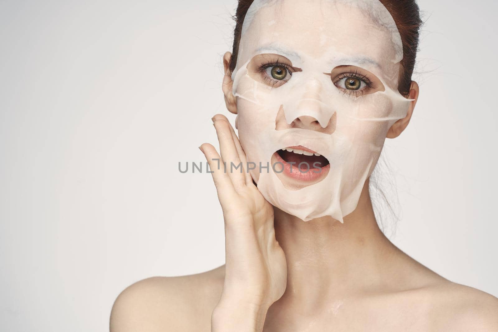 pretty woman naked shoulders face mask close-up skin care. High quality photo