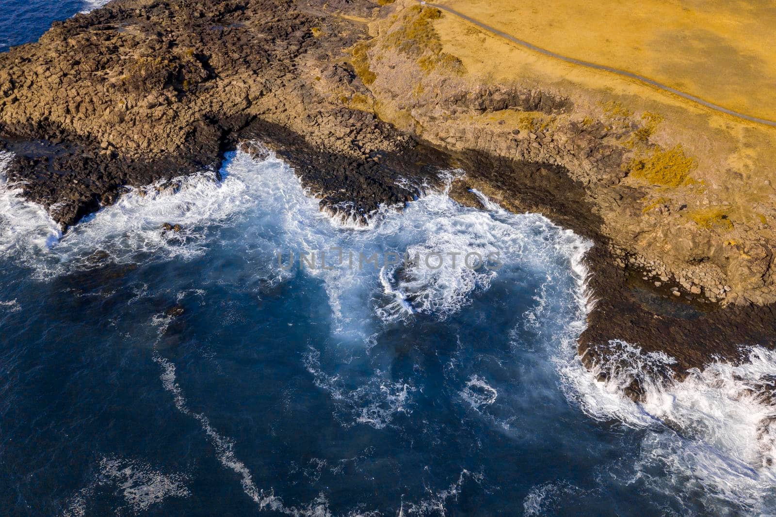 Drone aerial photograph of the ocean crashing against rocks in Kiama by WittkePhotos
