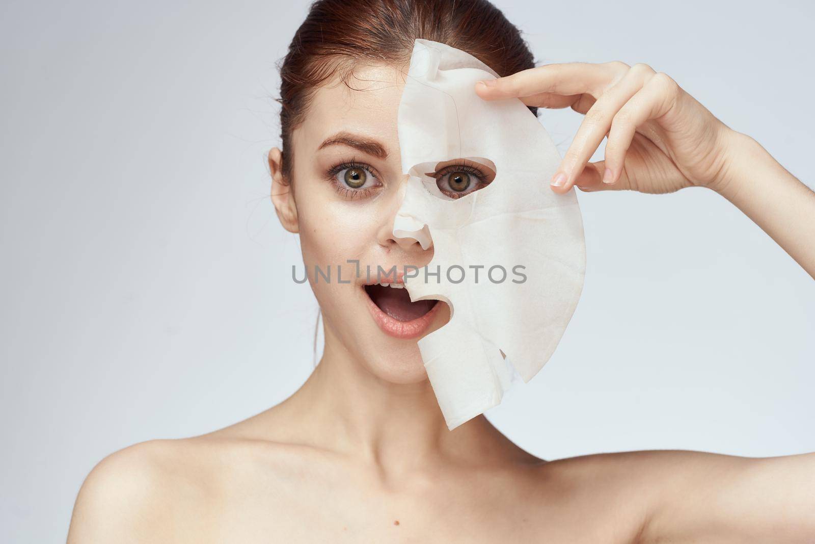 woman with bare shoulders and face mask skin care cosmetics by Vichizh