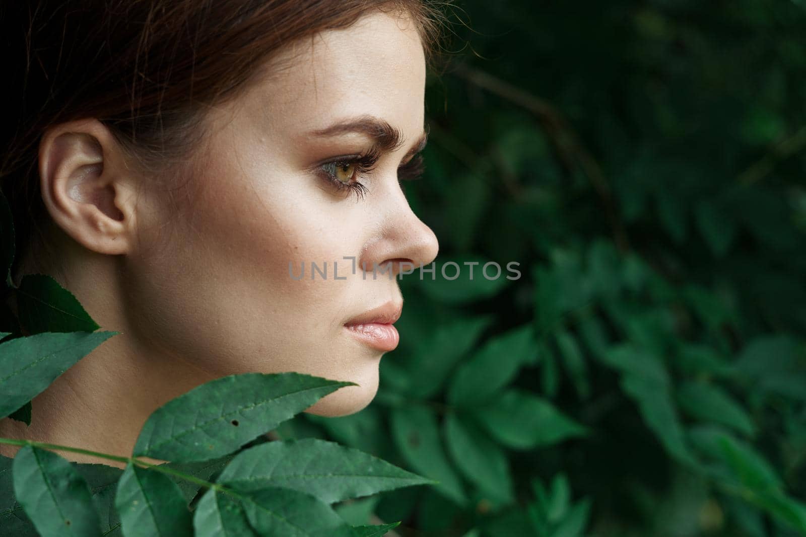 portrait of a woman Cosmetology nature green leaves glamor close-up by Vichizh