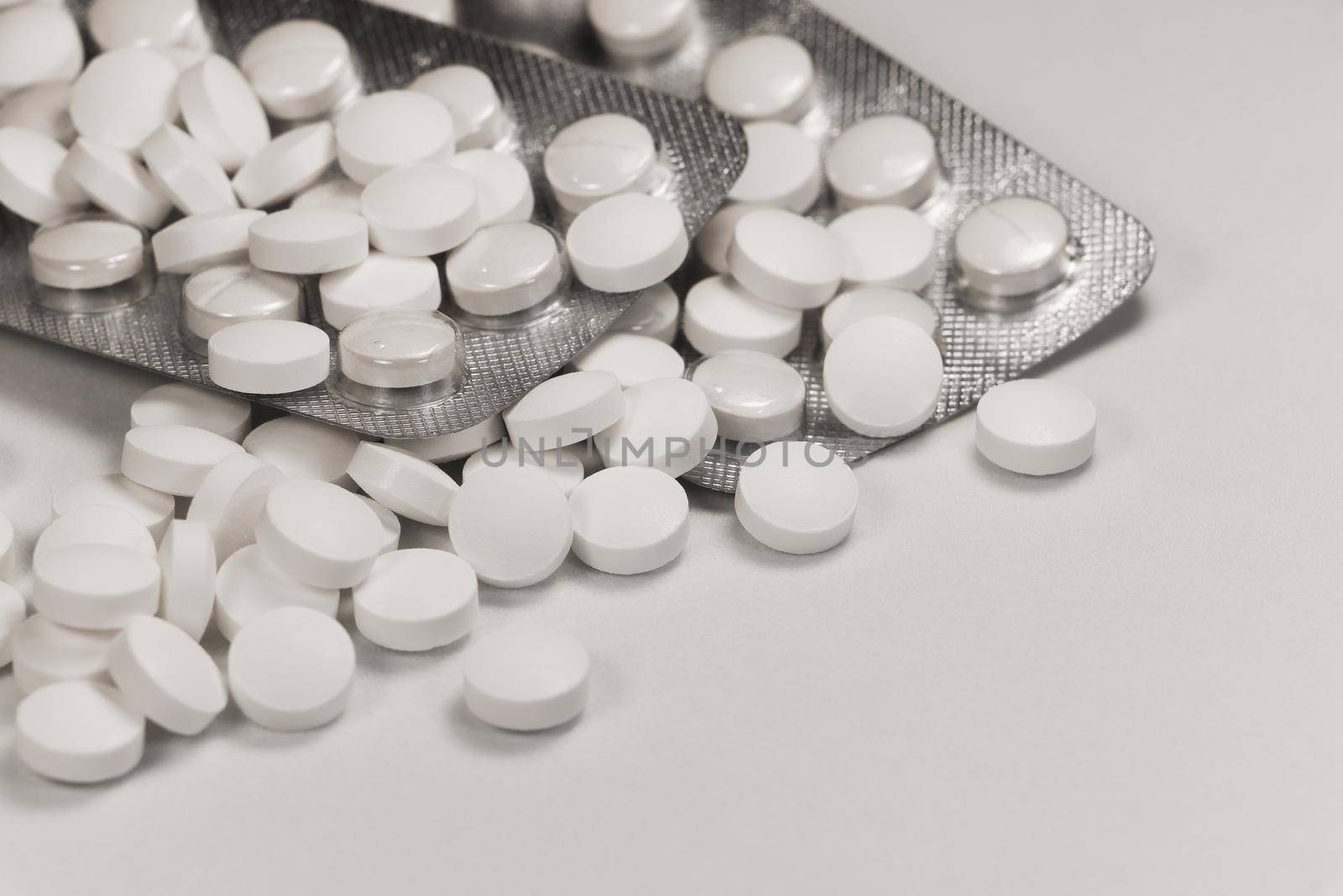 White Pill Medication And Tray Packaging Abstract Close-up On White by jjvanginkel