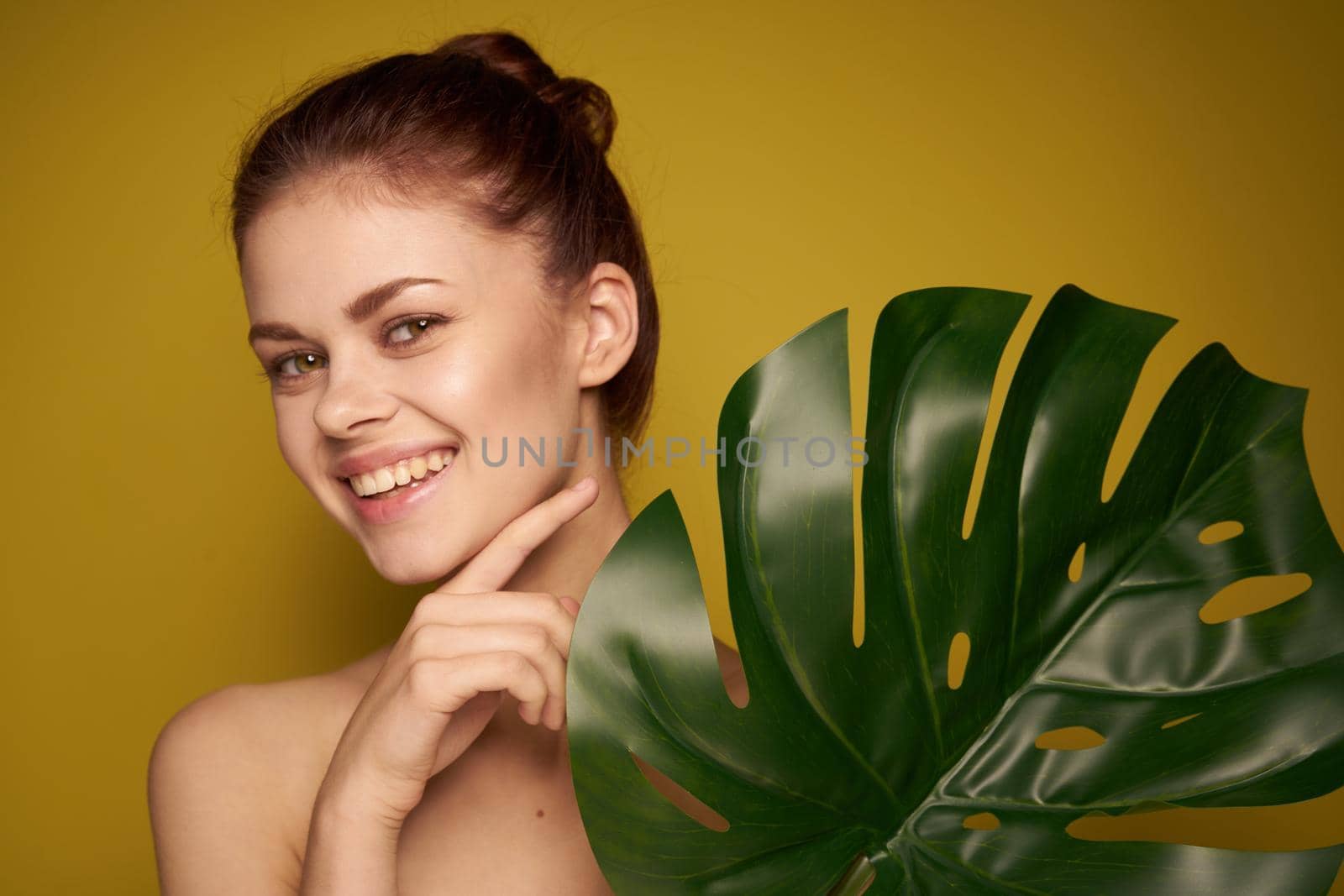 beautiful woman palm leaf bare shoulders spa treatments. High quality photo
