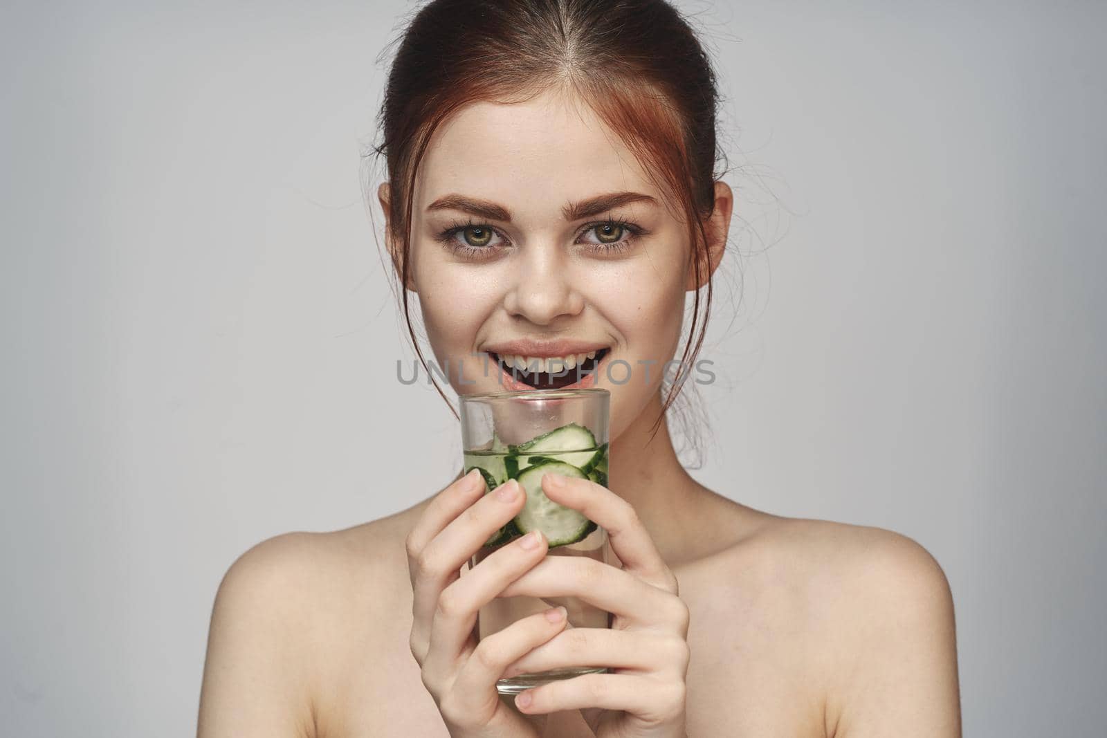 woman with cucumber drink health vitamins close-up. High quality photo