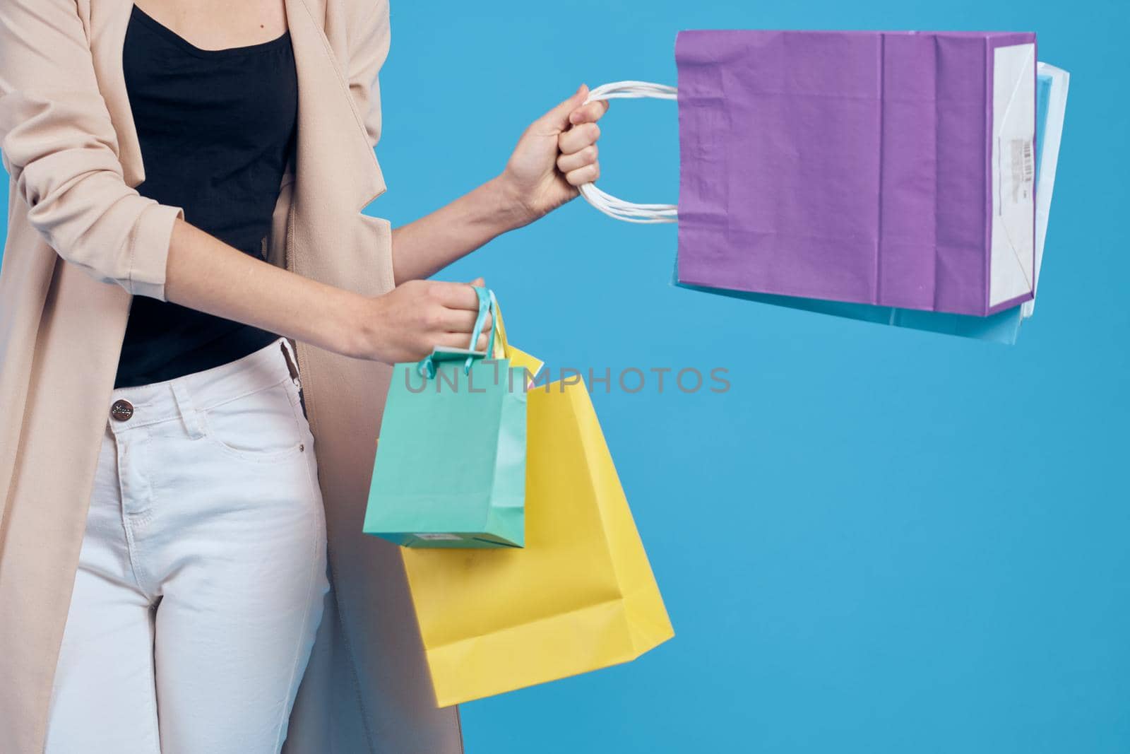 cheerful woman multicolored packs emotions shopping fashion blue background. High quality photo