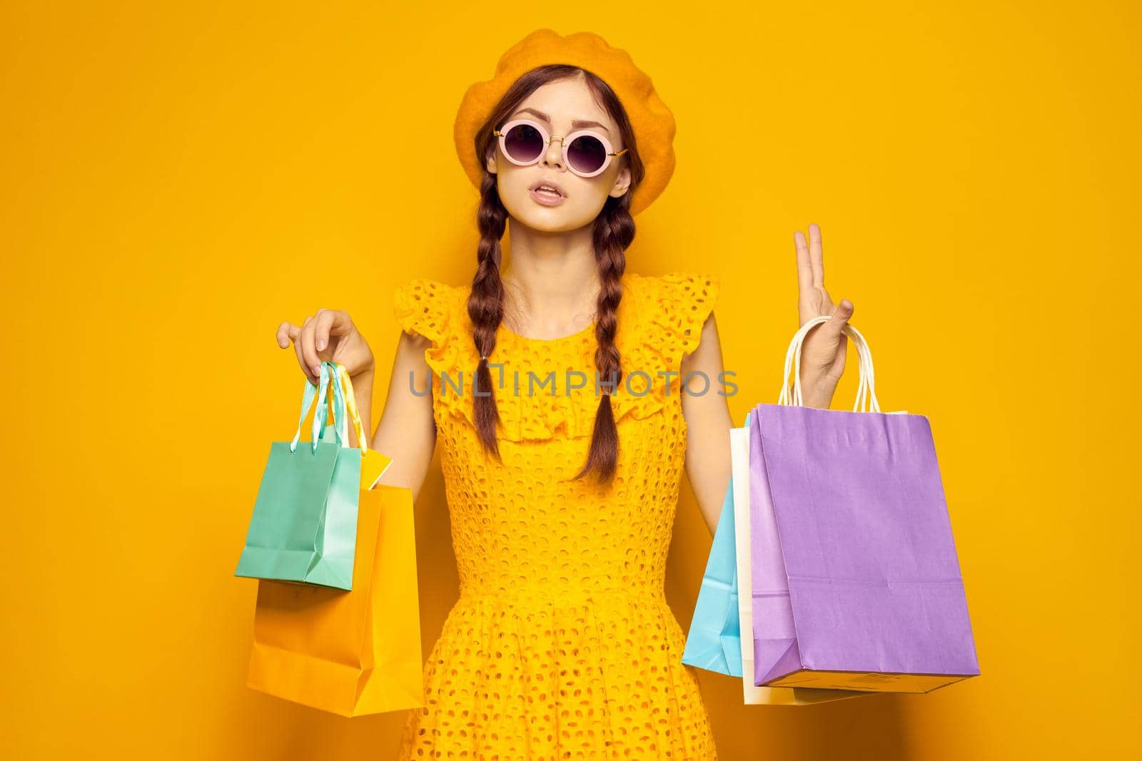 smiling woman in a yellow hat Shopaholic fashion style isolated background. High quality photo