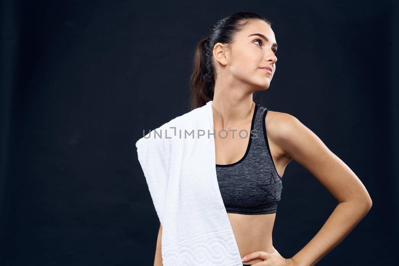 cheerful sports woman slim figure white towel in her hands. High quality photo