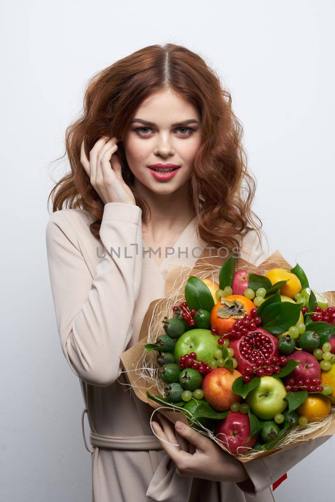 pretty woman smile posing fresh fruits bouquet emotions light background. High quality photo