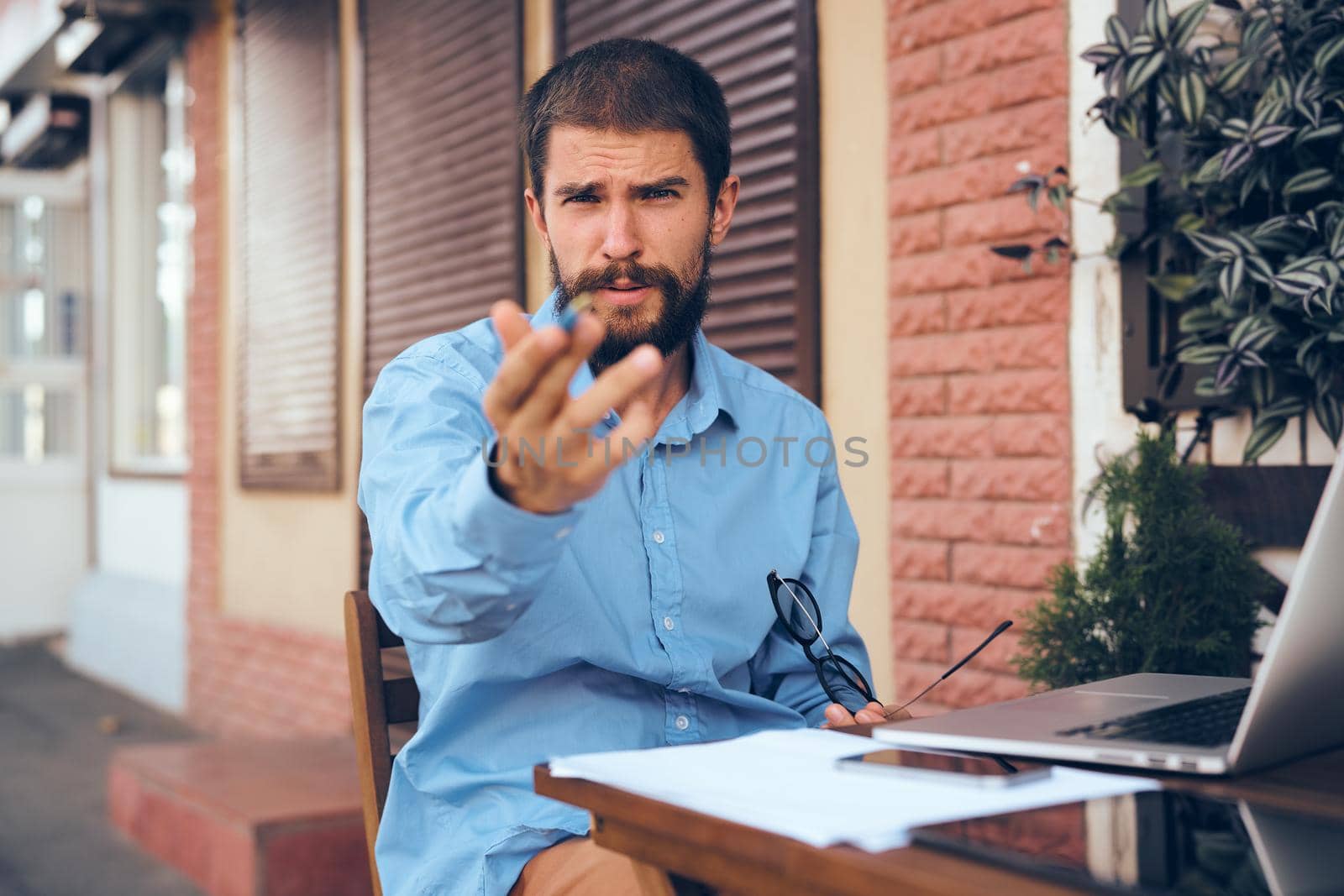 business man with laptop in cafe working internet. High quality photo