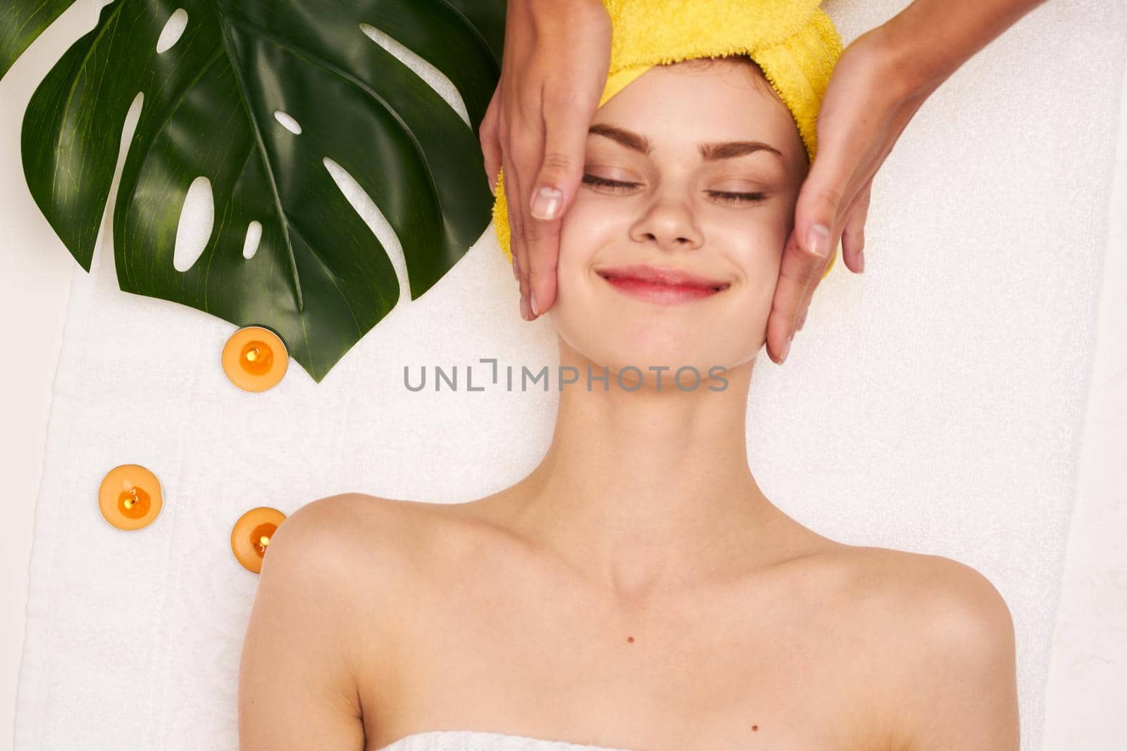 pretty woman with a towel on my head skin care light background by Vichizh