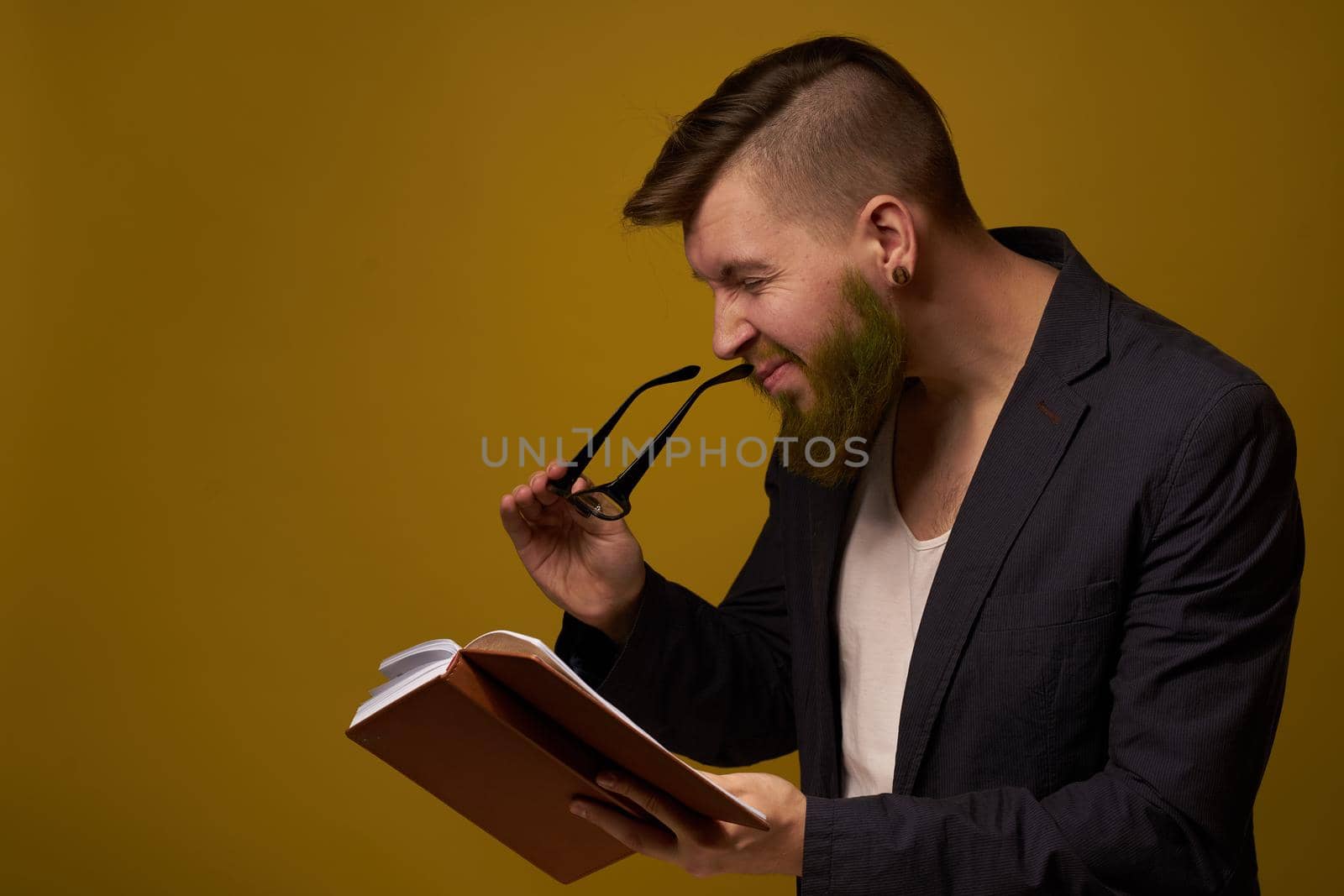 bearded man in a black jacket with a book in his hands education by Vichizh