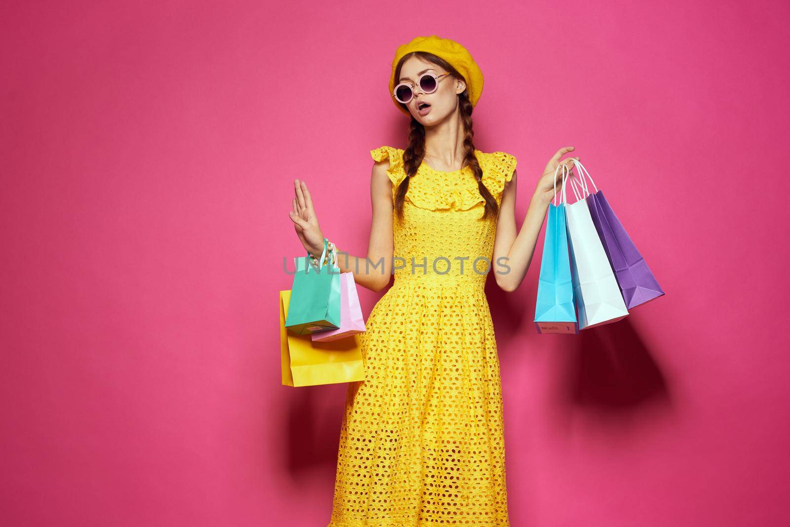 smiling woman wearing sunglasses posing shopping fashion studio model. High quality photo