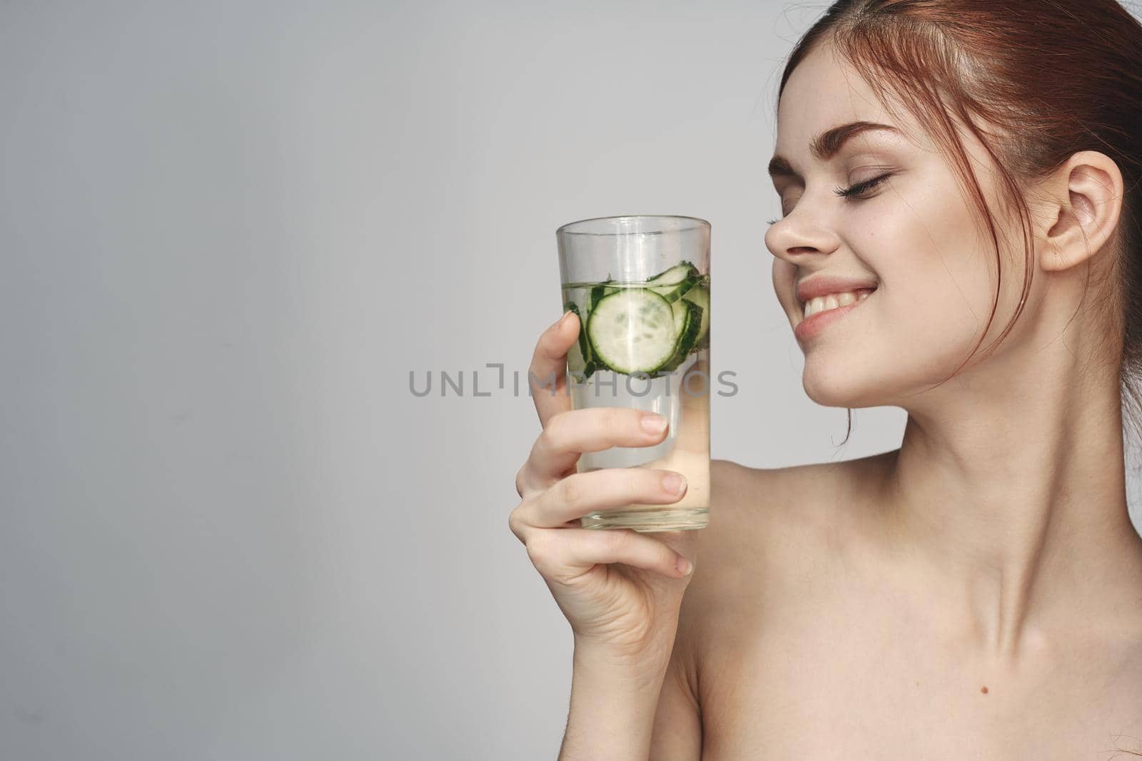 woman with cucumber drink health vitamins close-up. High quality photo