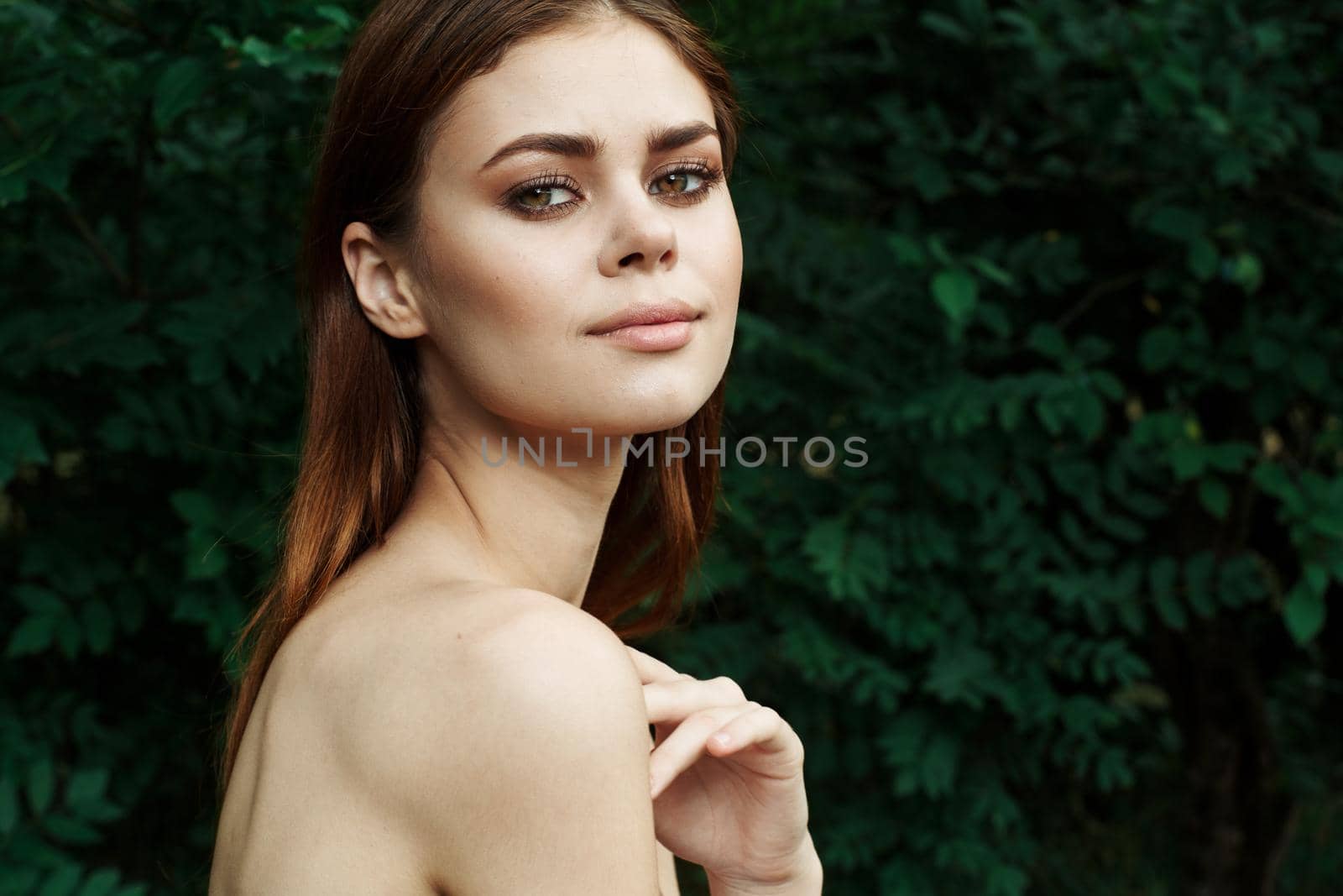 beautiful woman bared shoulders green bush cosmetics Lifestyle. High quality photo