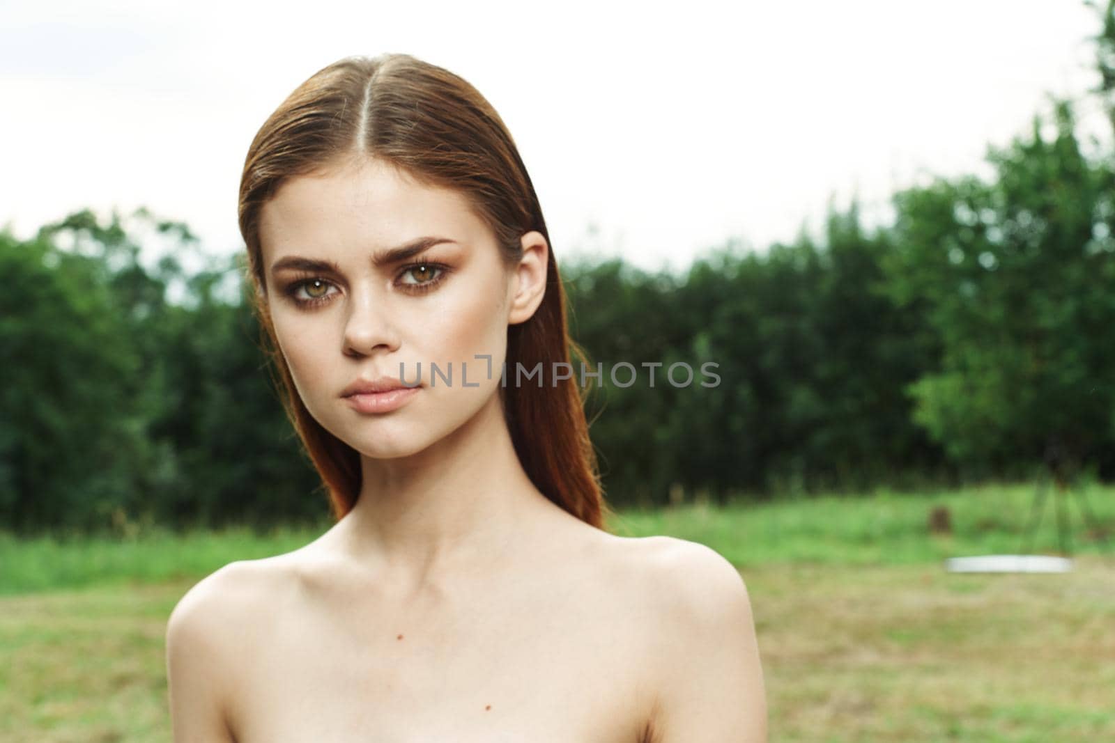 portrait of a woman in a field outdoors bare shoulders clear skin close-up by Vichizh