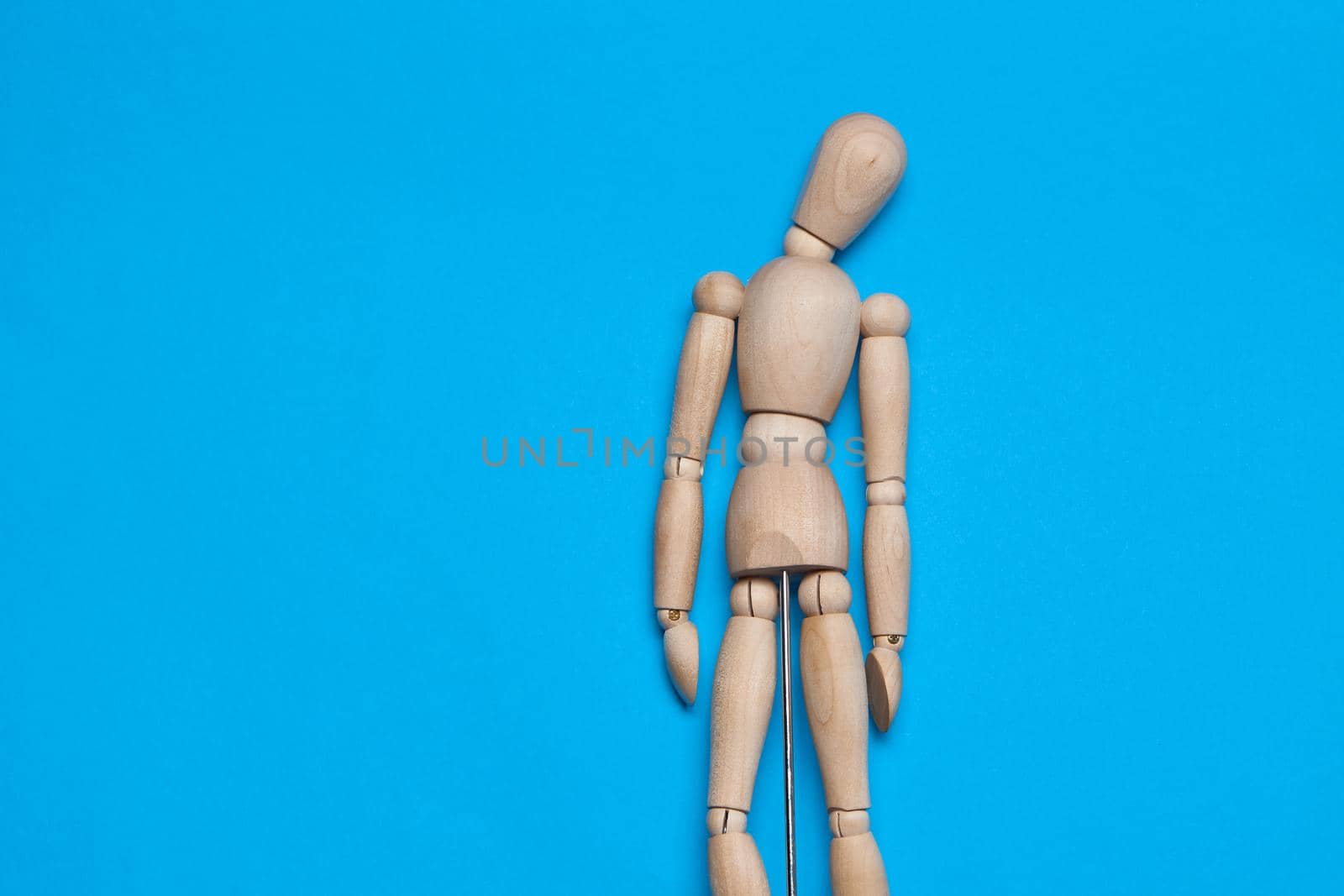 wooden man mannequin blue background design object. High quality photo