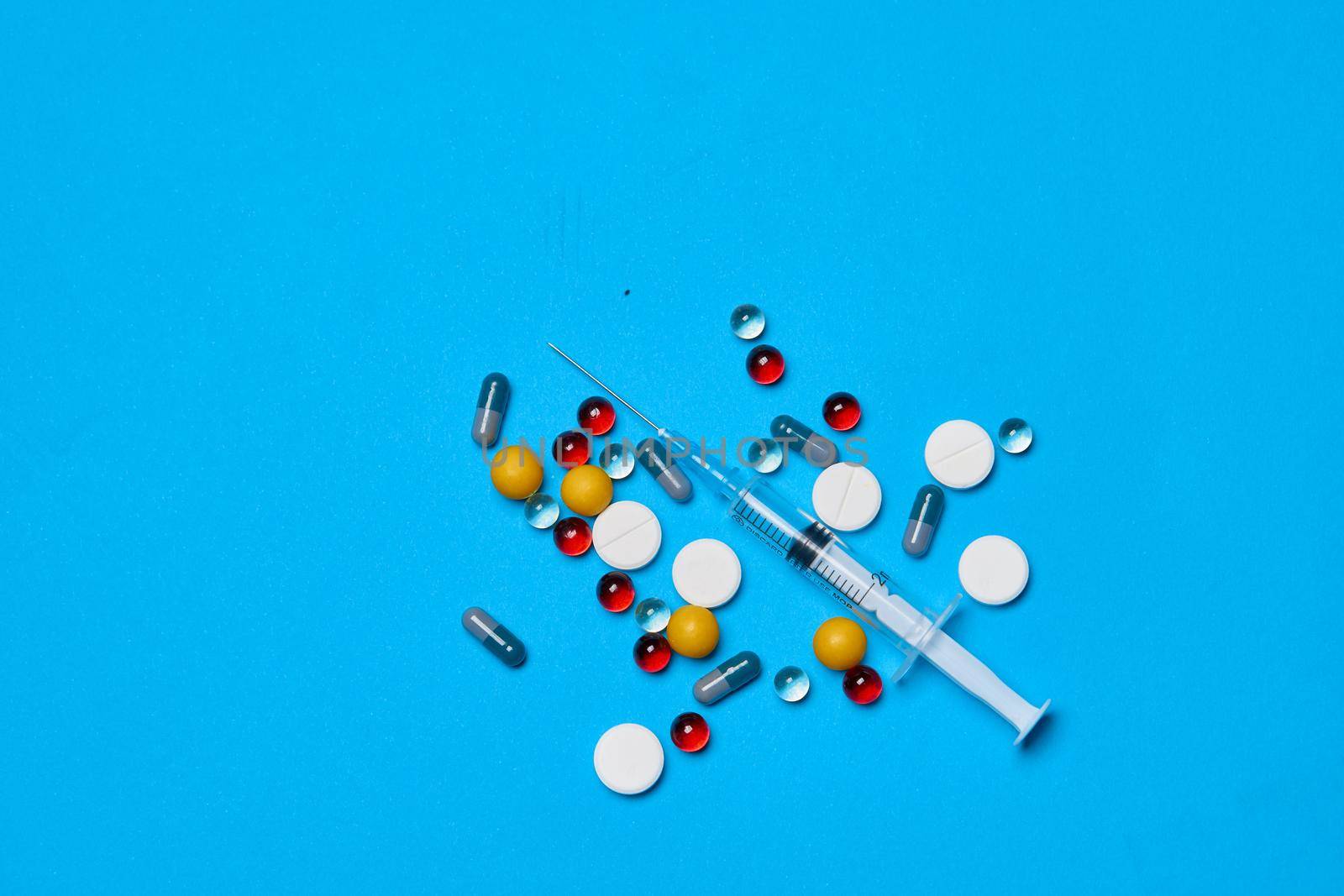 pain reliever Pharmaceuticals medicines syringe blue background. High quality photo