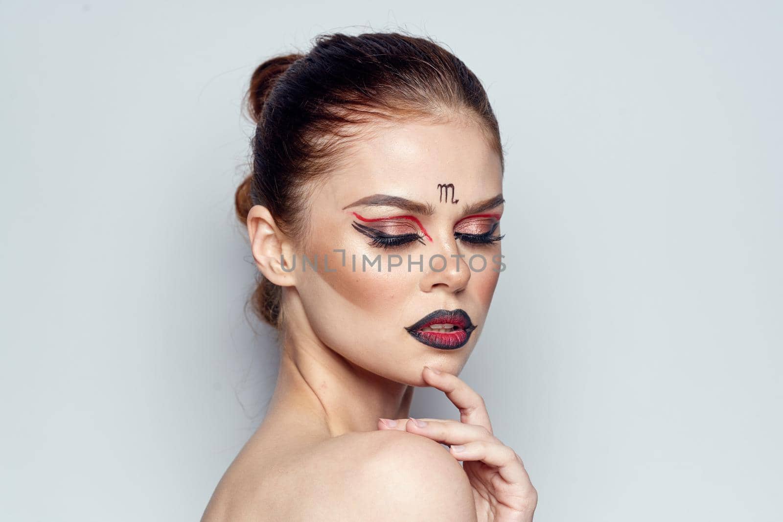 beautiful woman naked shoulders cosmetics bright makeup light background. High quality photo