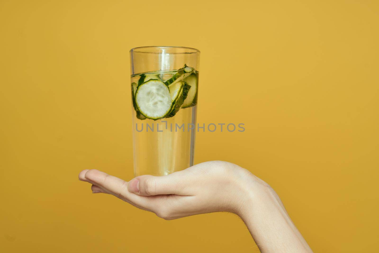 cucumber Fresh vitamins detoxification yellow background. High quality photo