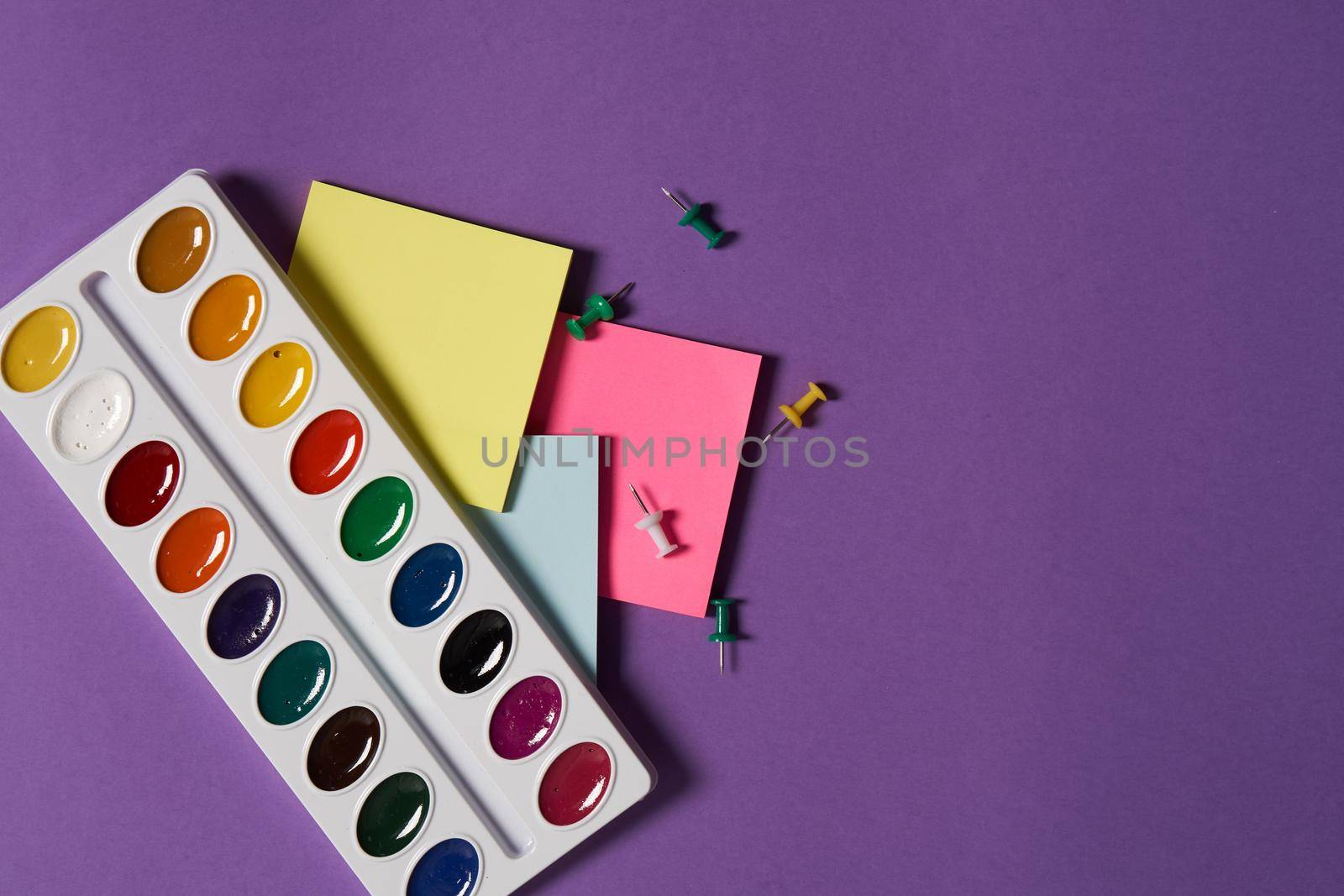 colorful stickers office supplies hobby drawing purple background. High quality photo