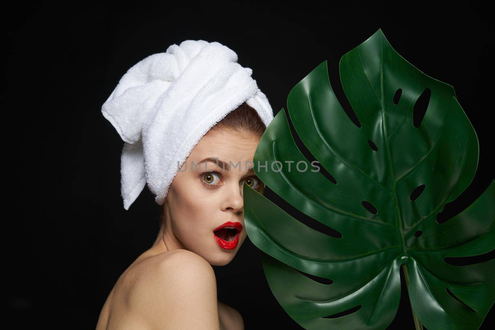 pretty woman with a towel on my head body care isolated background. High quality photo