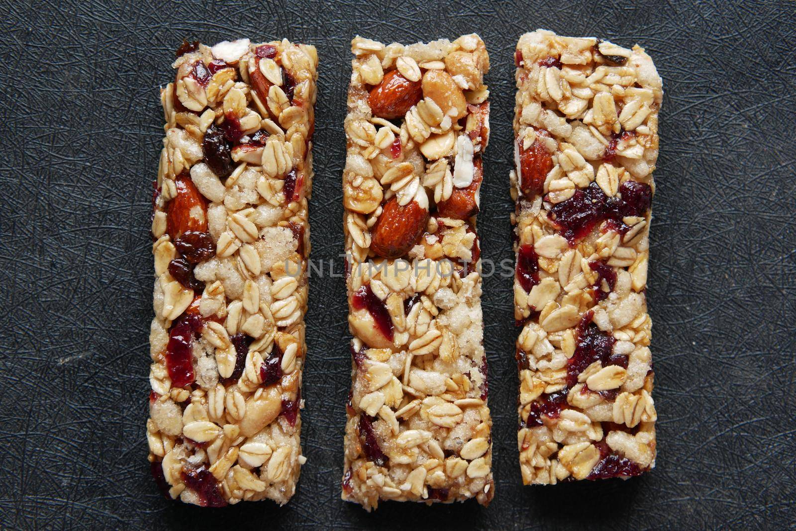 Almond , Raisin and oat protein bars on table .
