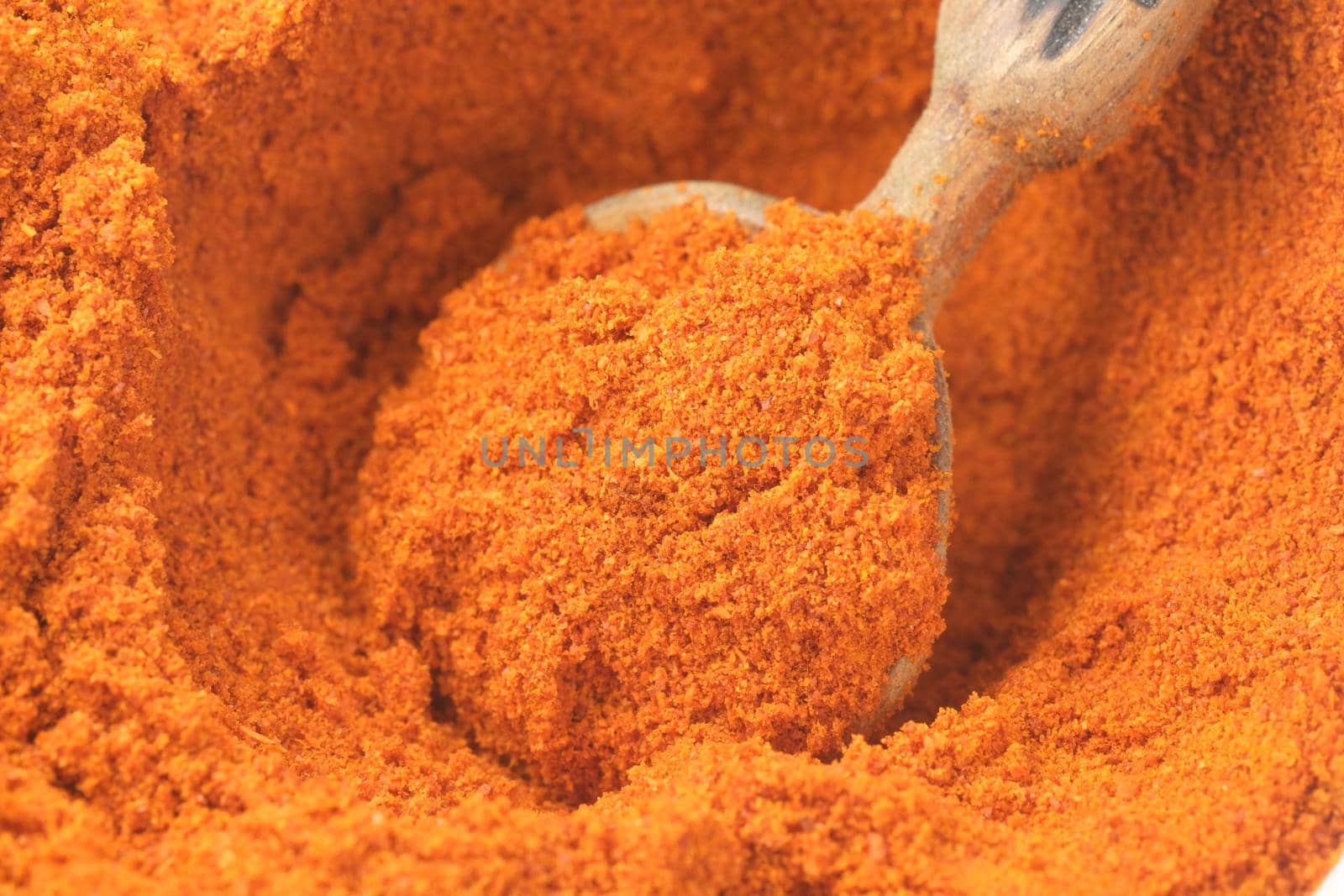 Chili powder and dried peppers on table background.