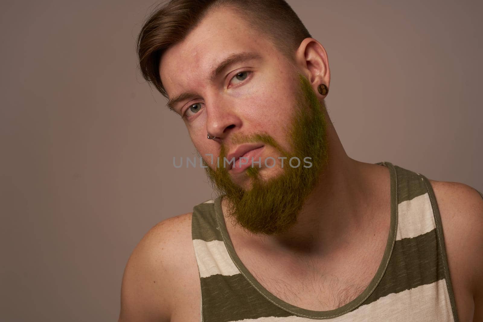 national bearded man in a striped jersey hipster tattoos on his arms. High quality photo
