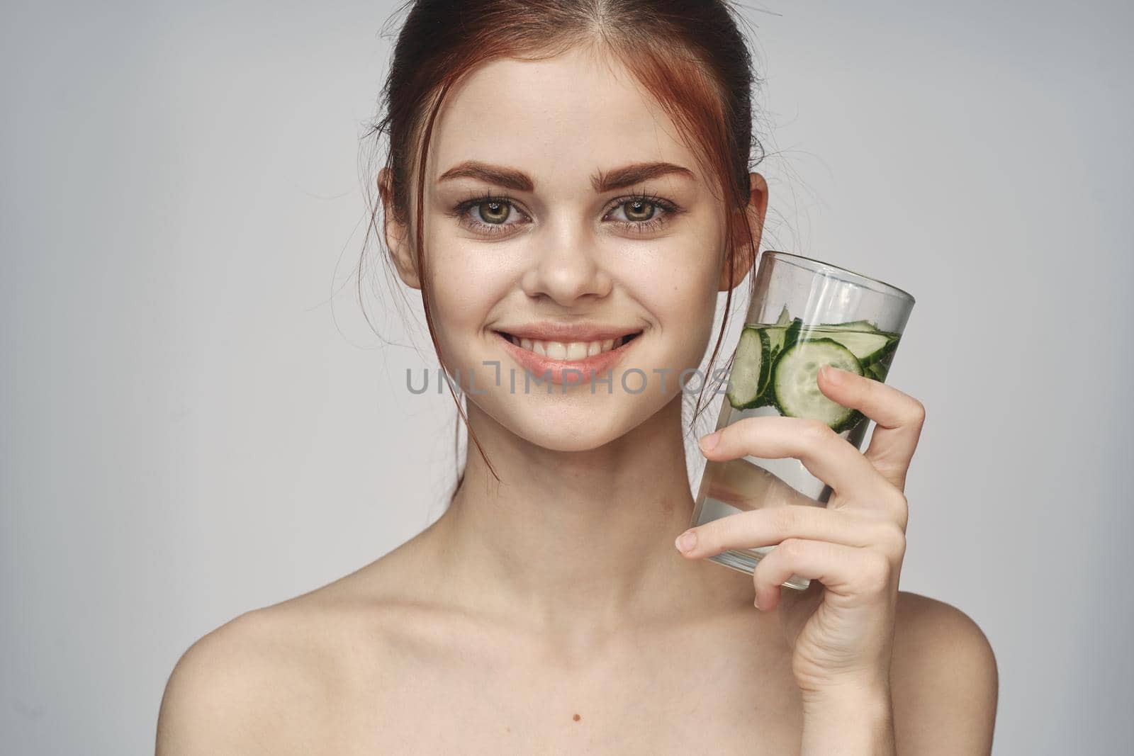 woman with bare shoulders cucumber health drink Fresh. High quality photo