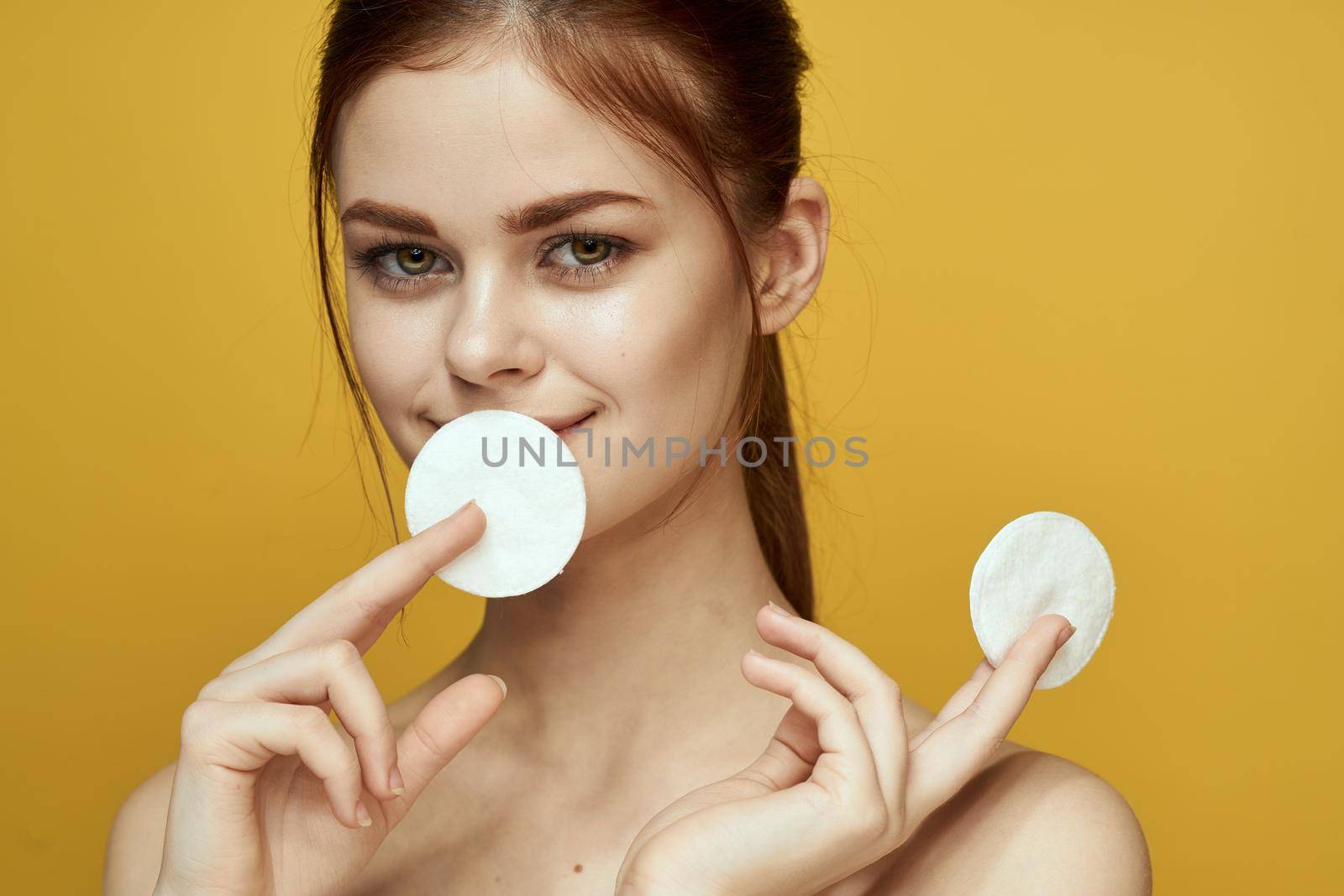 emotional women bare shoulders cotton pads and clear skin attractive look. High quality photo