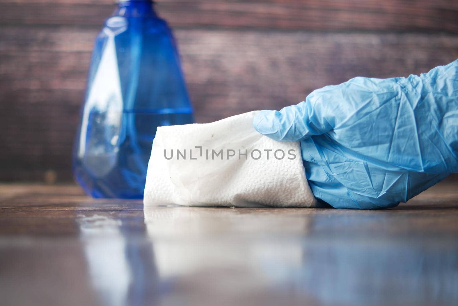 close up of person hand cleaning table with cloth .