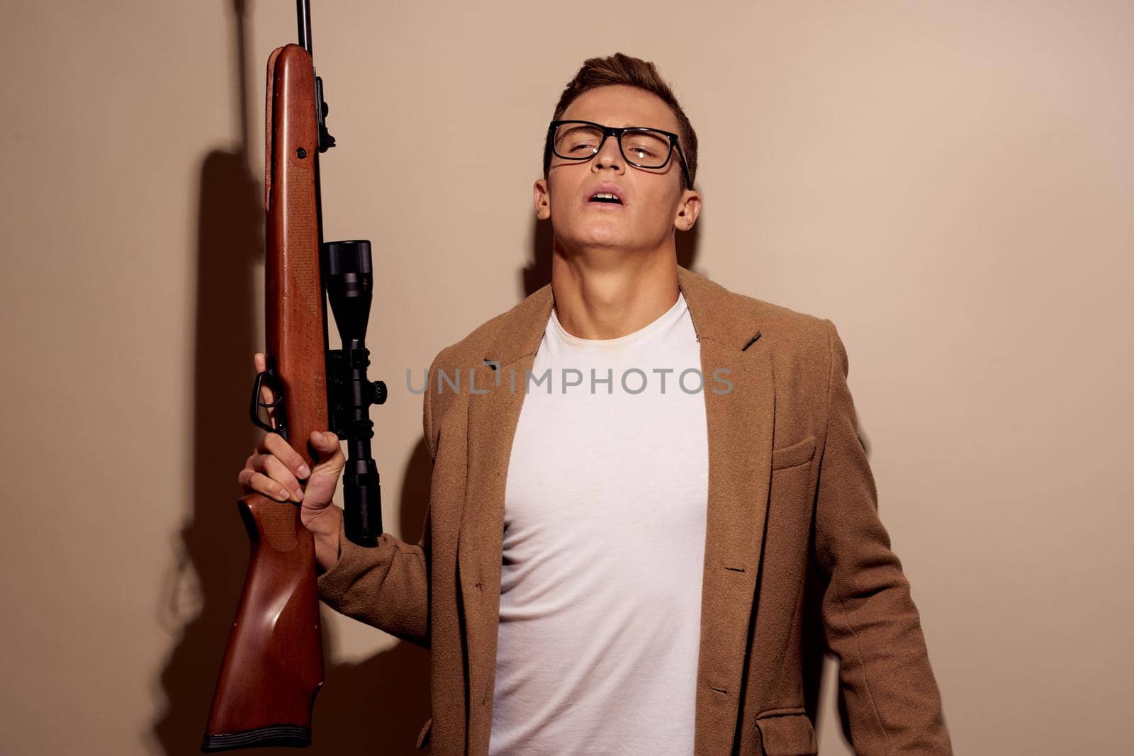 a person posing with glasses with a rifle in his hands isolated background by Vichizh