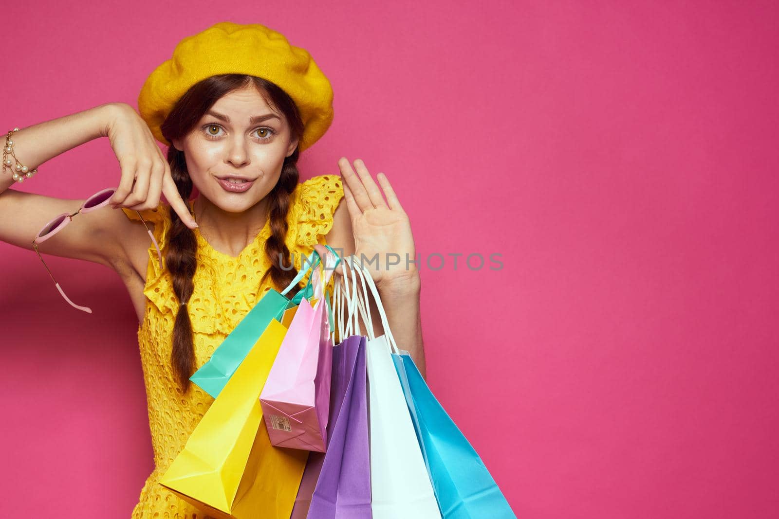 glamorous woman with multicolored bags posing isolated background. High quality photo