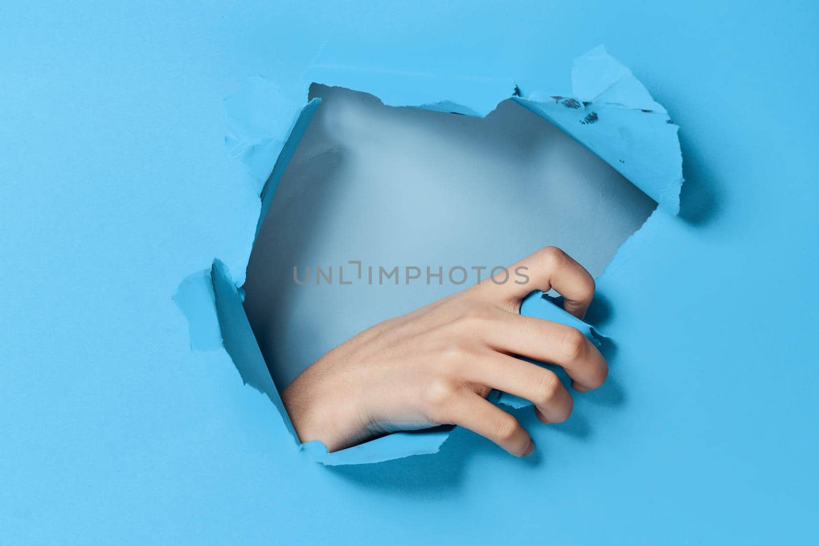 female hand blue background posing glamor model. High quality photo