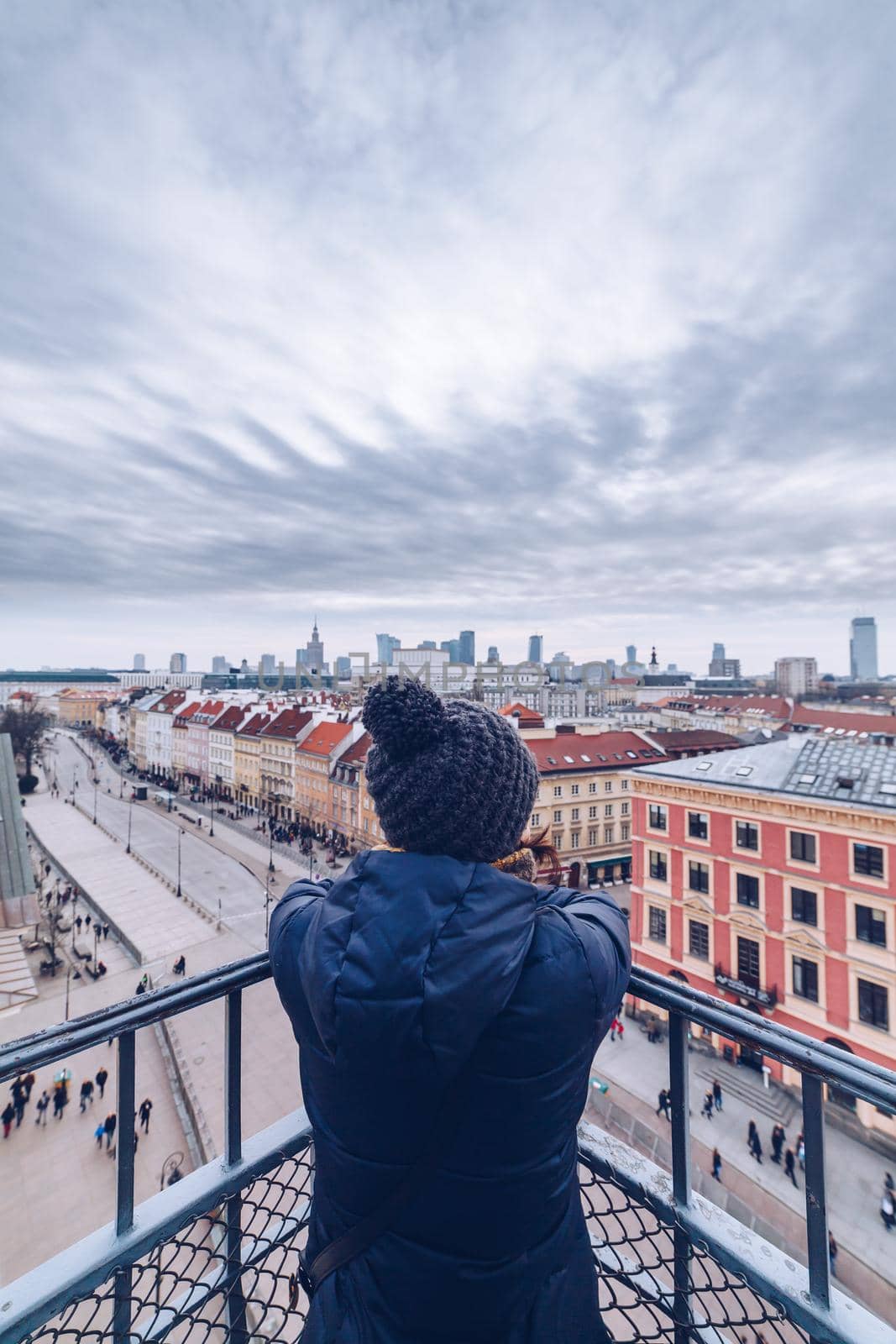 Tourist looking the Warsaw City Center from the tower during winter season by Sandronize