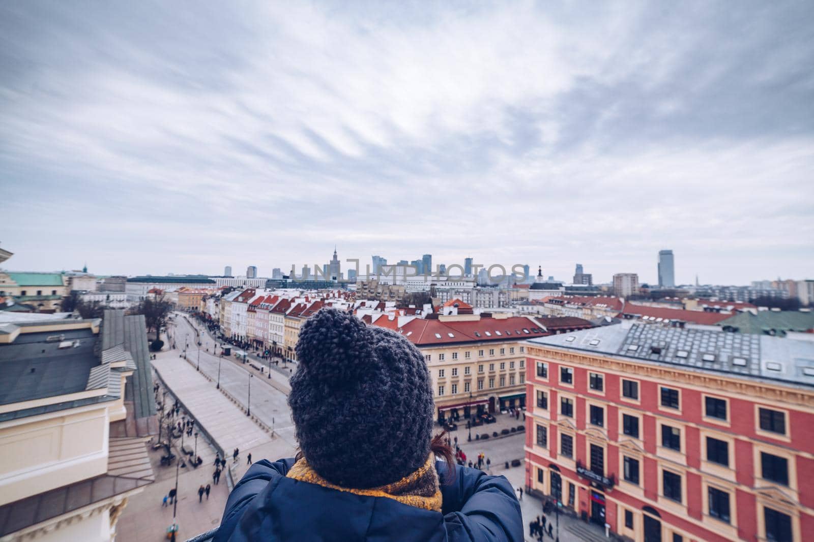 Tourist looking the Warsaw City Center from the tower during winter season by Sandronize