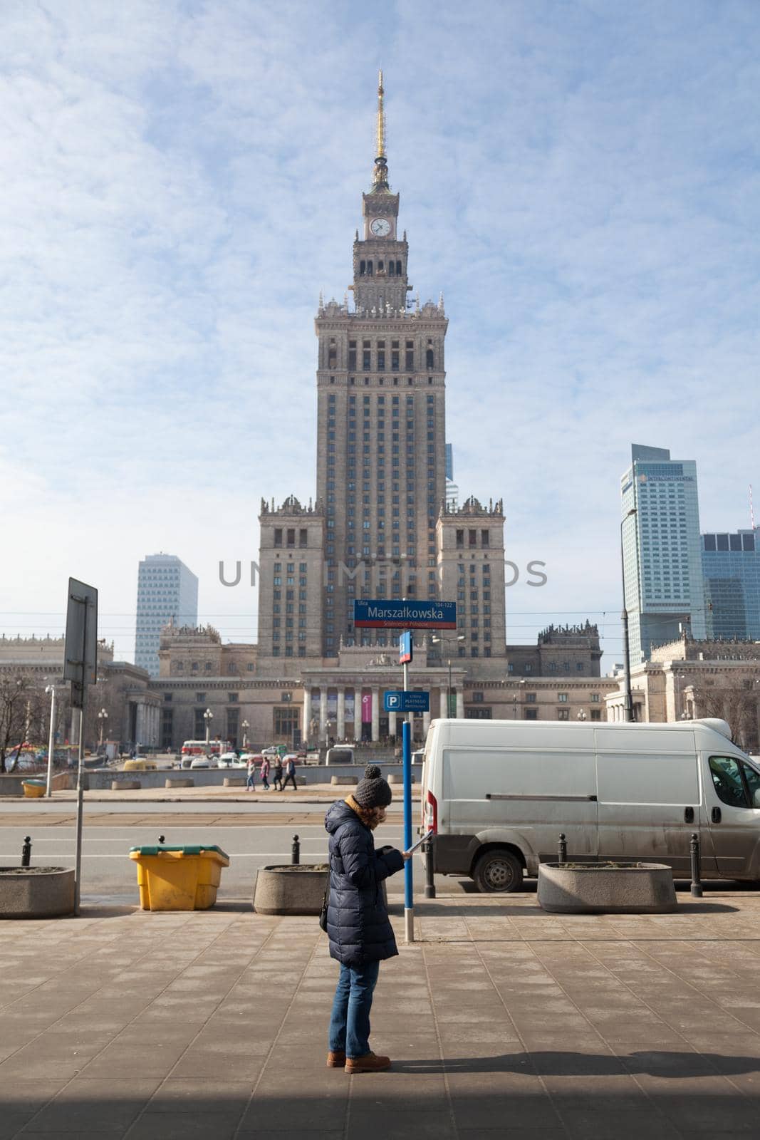 WARSAW, POLAND - March 2018 View of palace with tourist reading a map - Warsaw City Center.
