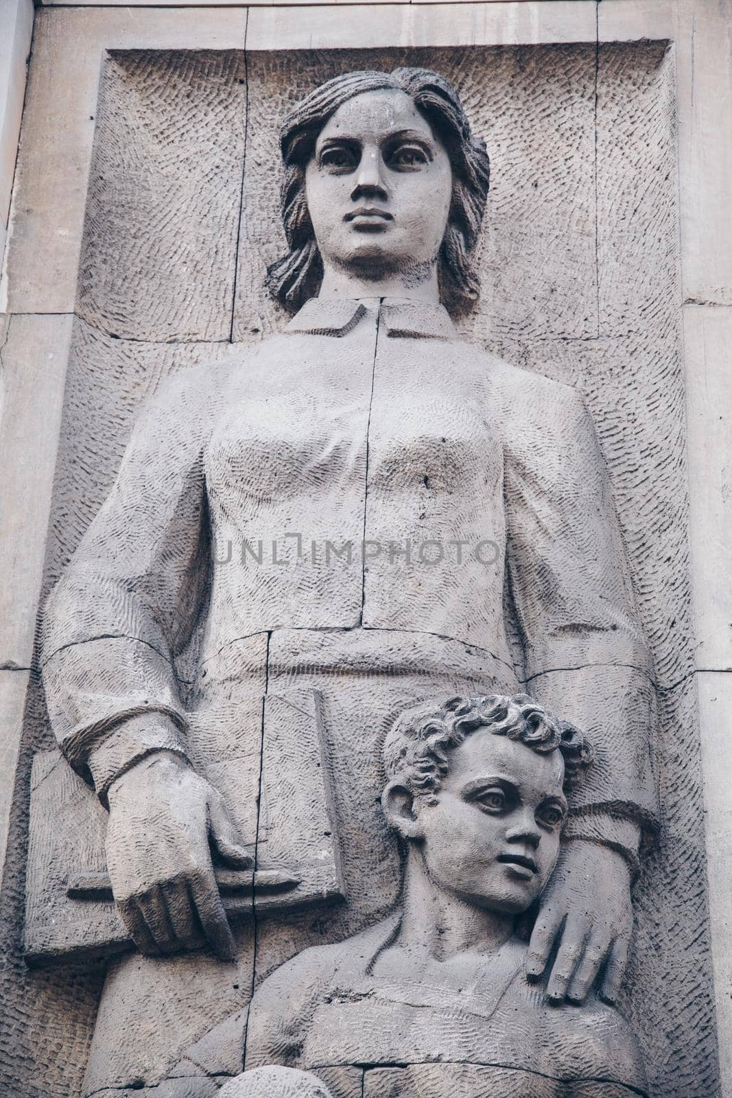 WARSAW, POLAND - March 2018 - A social realist relief of a socialist woman and kid in the center of Polish capital