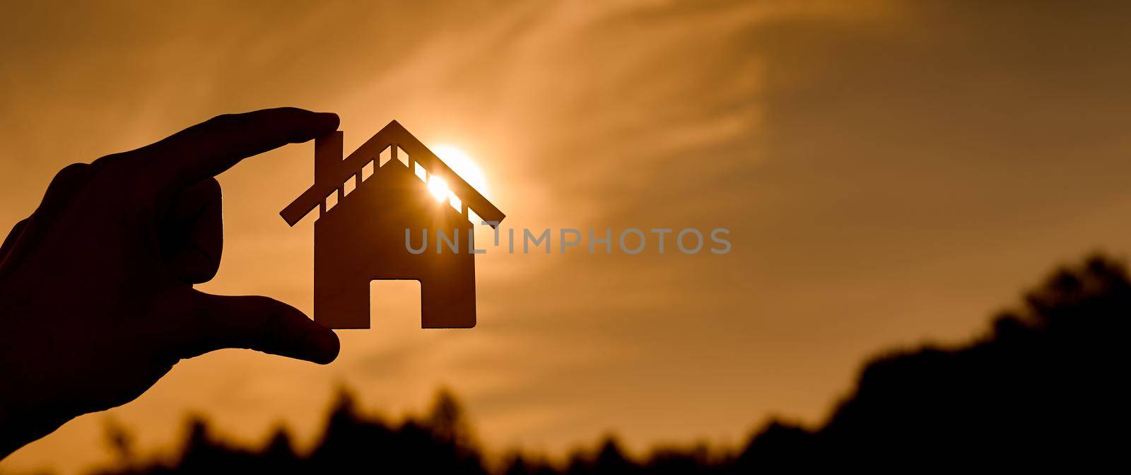 symbol of the house at sunset in the form of contours in women's hands by AntonIlchanka