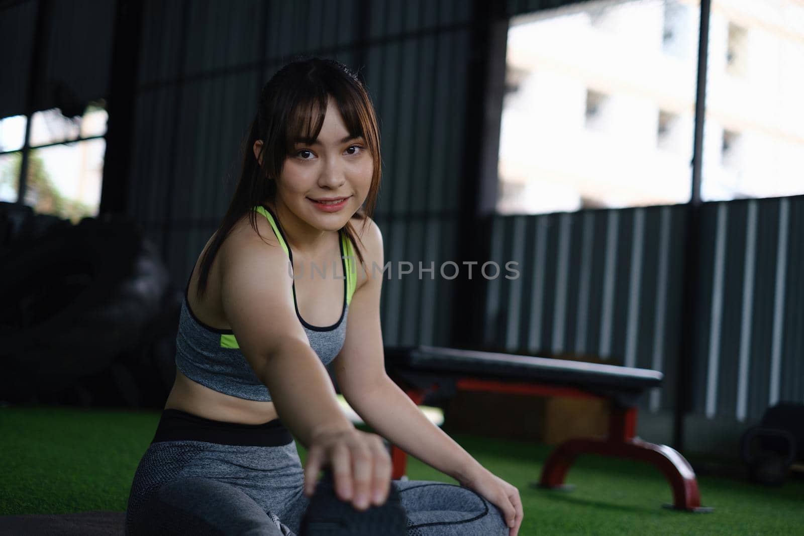 Sport woman warm up before exercise in fitness gym. Portrait sport and Healthy concept. by itchaznong