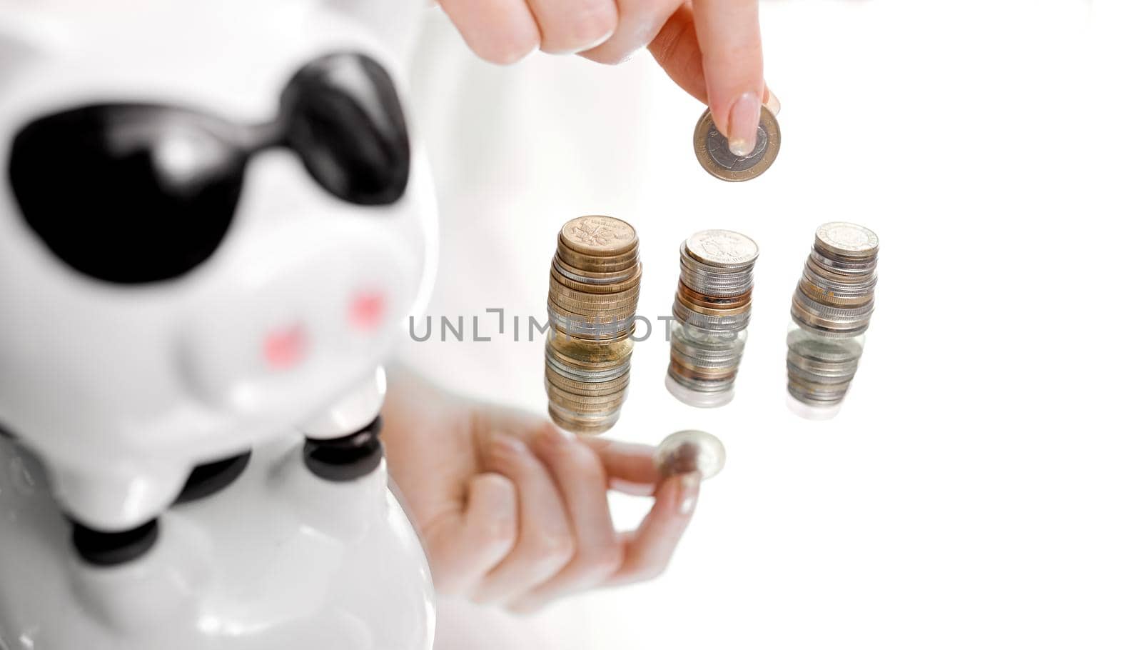 Close Up Of hand With Piggy Bank And Coins. High quality photo